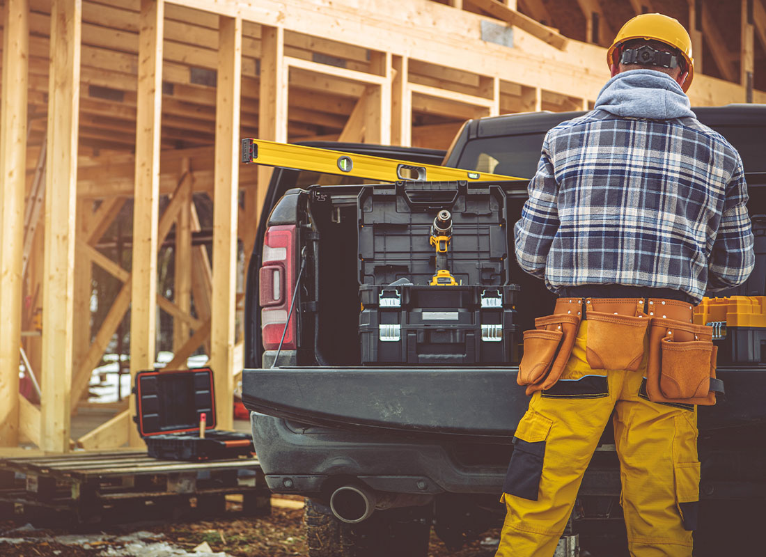 Insurance by Industry - View of Contractor Working Outdoors with a Pickup Truck Full of Tools