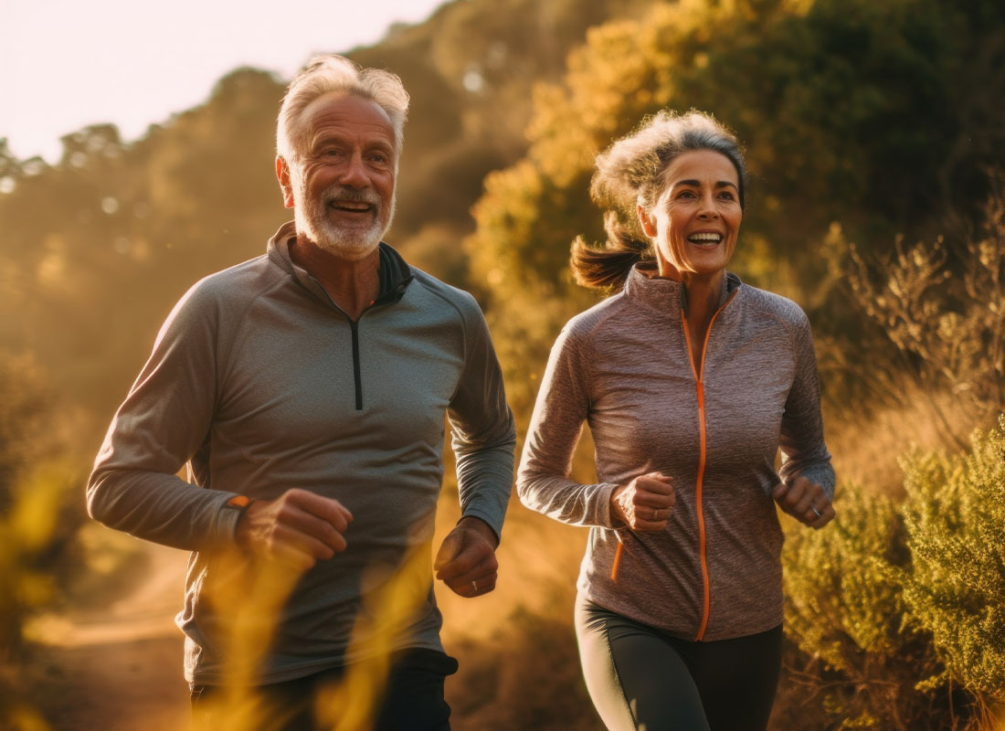 Medicare - Senior Couple Running Outdoors and Getting Exercise at Dusk