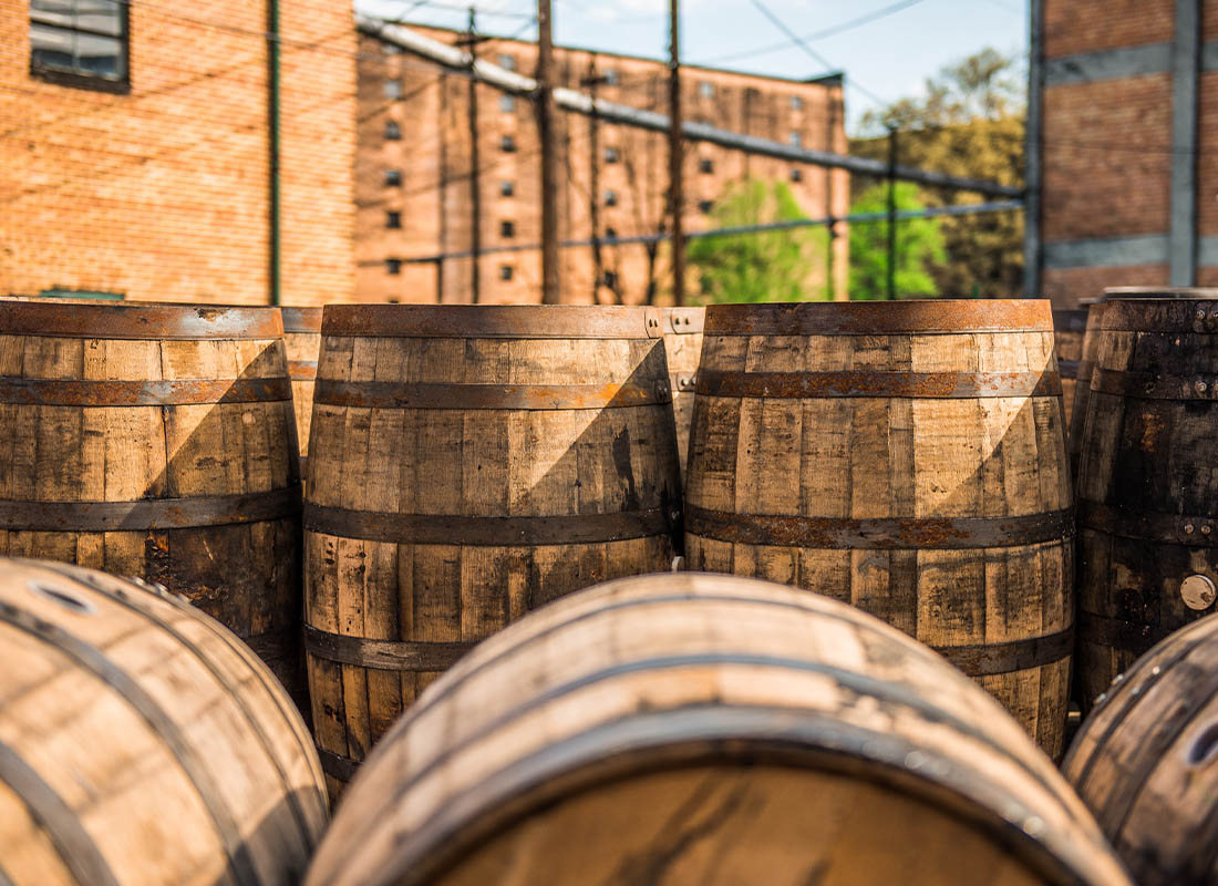 Read Our Reviews - Closeup of Whisky Barrels Outside of a Distillery